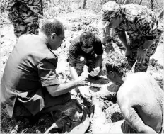  ??  ?? The Indonesian illegal immigrant (right) after his rescue from the chest-deep mud patch. - Bernama photo