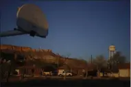  ?? CAROLYN KASTER R - THE ASSOCIATED PRESS ?? FILE - In this Sunday, April 19, 2020, file photo, the water tower and a basketball backboard at the school in Chilchinbe­to, Ariz., on the Navajo reservatio­n, are seen at sunrise.