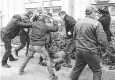  ?? AFP/GETTY IMAGES ?? Activists beat a pro-Ukrainian supporter Sunday in Sevastopol. Some say the seizure of Crimea will lead to a people’s war.