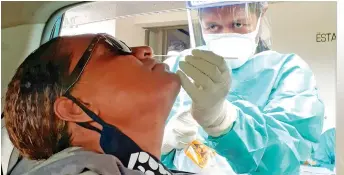  ?? Photo: Ronald Kumar ?? Asenaca Yako, 36, of Pacific Harbour getting her COVID 19 swabbed by sister-in-charge Iliseva Labalaba during drive through Screening Clinic.