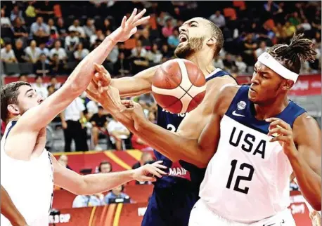  ?? PHOTO BYLINE IS CAPS, DIN LIGHT, 6PT, KERNING -25 ?? France’s Rudy Gobert (centre) fights for the ball with Joe Harris (left) and Myles Turner of the US during the Basketball World Cup quarter-final game between US and France in Dongguan on Wednesday.