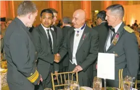  ?? ALFREDO FLORES VIA AP ?? From left, Vice Admiral Michael Rogers; Paul Monteiro, vice chairman and co-founder of Nowruz Commission; Bijan R. Kian and Lt. Gen. Michael Flynn talk during the Fifth Annual Nowruz Commission Gala at the Andrew W. Mellon Auditorium in Washington.