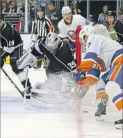  ?? Reed Saxon Associated Press ?? KINGS GOALIE Darcy Kuemper finds himself in fierce battle for the puck during Sunday’s game.