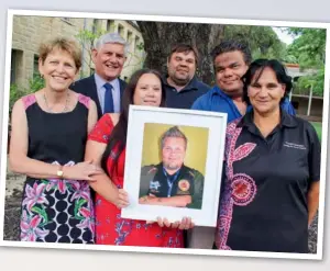  ??  ?? Jason Bartlett’s widow, Jaimee Bartlett, holding a treasured photograph of her late husband, with (left to right) Dr Sandra Thompson (WA Centre for Rural Health), Indigenous Health Minister Ken Wyatt AM and Adrian Bartlett (both cousins of Jason), his...