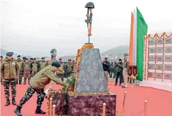  ?? — PTI ?? CRPF personnel pay tribute at a memorial to the 40 CRPF jawans, who were killed in the Pulwama terror attack in February last year, at Letapora of Pulwama District of South Kashmir on Friday.