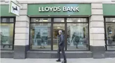  ?? — Reuters ?? A man walks past a branch of Lloyds bank in central London.