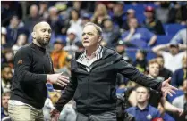  ?? TULSA WORLD 2023 ?? Oklahoma State wrestling coach John Smith (right), a two-time Olympic champion, says the majority of kids who get involved in sports aren’t looking to get rich. “What’s that going to do with our society?” Smith says of NIL and related issues.