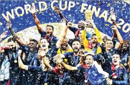  ?? AFP ?? France players celebrate with the trophy during the presentati­on ceremony after beating Croatia in the final of the Russia 2018 World Cup at the Luzhniki Stadium in Moscow on July 15.