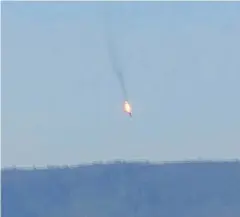  ??  ?? HOSTILE ACT: Film footage shows a Russian warplane on fire before crashing on a hill in Turkey on Tuesday. Turkey shot down the jet, claiming it had violated Turkish airspace.