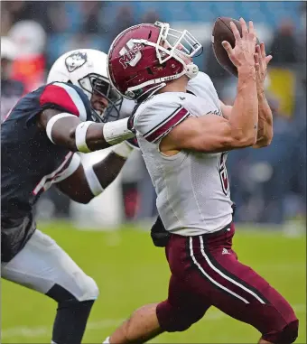  ?? JESSICA HILL/AP PHOTO ?? UMass wide receiver Andy Isabella reaches back to make a catch while being pursued by UConn’s Tahj Herring-Wilson during the second half Saturday’s game at Rentschler Field in East Hartford. UMass rallied in the fourth quarter to beat the Huskies 22-17.