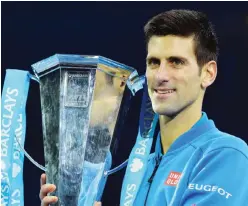  ??  ?? LONDON: Serbia’s Novak Djokovic poses with the ATP trophy after winning the men’s singles final match against Switzerlan­d’s Roger Federer on day eight of the ATP World Tour Finals tennis tournament in London yesterday. — AFP