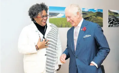  ?? AP ?? Britain’s Prince Charles (right), greets Barbados’ Prime Minister Mia Amor Mottley ahead of their bilateral during the COP26 summit at the Scottish Event Campus (SEC) in Glasgow on Monday. Mottley is wearing a Story ans Myth blessing bead mask chain.