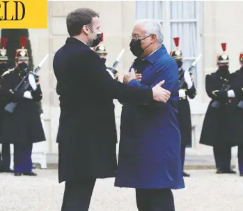  ?? GONZALO FUENTES/ REUTERS ?? French President Emmanuel Macron, who tested positive for COVID-19 on Thursday, welcomes Portugal's Prime Minister Antonio Costa at the Elysée Palace on Dec. 16. Costa was in self-isolation Thursday awaiting test results.