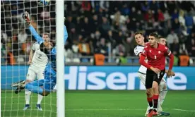  ?? Photograph: Levan Verdzeuli/Getty Images ?? Lawrence Shankland scores Scotland’s late equaliser in Georgia.