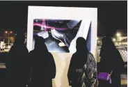  ?? Nariman El-Mofty / Associated Press ?? Women watch a video on driving at a road safety event held for female motorists at a mall in Riyadh.