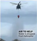  ??  ?? AIR TO HELP Water is dropped from helicopter