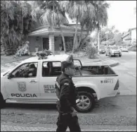  ?? AP/JORGE SAENZ ?? Police patrol Wednesday outside the home of former FIFA executive Nicolas Leoz who is under house arrest in Asuncion, Paraguay. Leoz has said he’ll fight extraditio­n to the U.S.