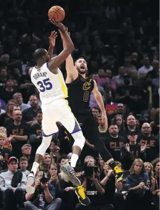  ?? GREGORY SHAMUS/GETTY IMAGES ?? Kevin Durant made big shots over Kevin Love and every other Cavaliers player who tried to guard him Wednesday. Durant scored 43 points for Golden State in a 110-102 victory over Cleveland.