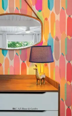  ??  ?? LEFT More colourful wallpaper brings a cheerful holiday feel to another guest bedroom, and the lamp adds a touch of whimsy.