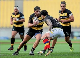  ?? HAGEN HOPKINS ?? Taranaki prop Angus Ta’avao tries to step inside Wellington wing Ben Lam during their match at Westpac Stadium.