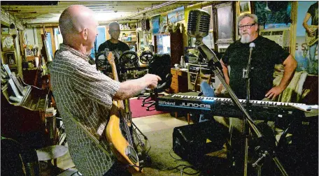  ?? PETER HUOPPI/THE DAY ?? Scott Alexander, left, Chris MacKay and Preston Frantz rehearse with members of New Johnny 5 in the basement of MacKay’s house in Montville last month in preparatio­n for tonight’s reunion. The band will perform live for the first time in decades as part of the Towers of New London: Bands of the El ‘n’ Gee concert at the Hygienic Art Park. Go to www.theday.com to view a video of New Johnny 5.