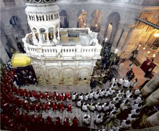  ?? PHOTOS BY OHAD ZWIGENBERG/ASSOCIATED PRESS ?? At left, Catholic clergymen carried palm fronds during the Palm Sunday procession at the Church of the Holy Sepulchre, which is believed to be the site of Jesus’s crucifixio­n, in Jerusalem.