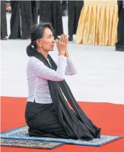  ?? EPA ?? Aung San Suu Kyi pays homage to her father and other leaders of the pre-independen­ce Myanmar government yesterday.