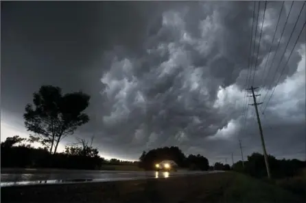  ?? MATHEW MCCARTHY, RECORD STAFF ?? Storm clouds cross Ebycrest Road near Breslau on Friday. In Hawkesvill­e, a tornado touched down. And in Kitchener, blues fans ran for shelter.