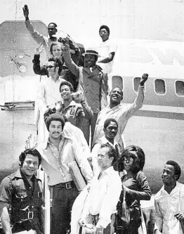  ?? THE GLEANER ARCHIVES ?? OFF ON TOUR: Byron Lee (front row, left) and members of the Dragonaire­s are seen at the Palisadoes Airport before they left the island for their North American tour in this 1971 file photograph.