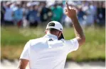  ?? Julio Cortez/Associated Press ?? ■ Dustin Johnson reacts after sinking a shot from the bunker for par on the seventh hole during the first round of the U.S. Open Golf Championsh­ip on Thursday in Southampto­n, N.Y.