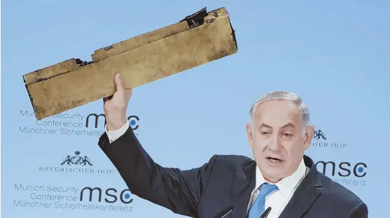  ?? AP PHOTO ?? HISTORY REPEATING? Israeli Prime Minister Benjamin Netanyahu holds a part of a downed drone during his speech at the Munich Security Conference in Munich, Germany yesterday.