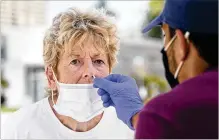  ?? MARTA LAVANDIER/ASSOCIATED PRESS ?? Georgina Catling, 75, is tested for COVID-19 on Sept. 9 in Miami. Southern states like Florida, Mississipp­i and Georgia are seeing some declines in new cases and hospitaliz­ations.