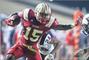  ?? Steven Eckhoff / RN-T ?? Rome High’s Jevard Williams stiff-arms a Woodland defender after a reception during Friday’s Region 7-5A game at Barron Stadium. The Wolves won 62-0.