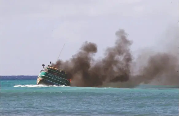  ?? THE STAR-ADVERTISER VIA AP ?? A grounded fishing boat called Pacific Paradise caught fire on Saturday, Oct. 14 near Kaimana Beach in Waikiki. No injuries were reported.