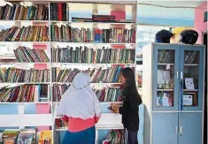  ??  ?? Instilling good habits: Children browsing for books at the TBM Kolong. — AFP