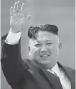  ??  ?? Kim Jong-un waves during the parade in Pyongyang.