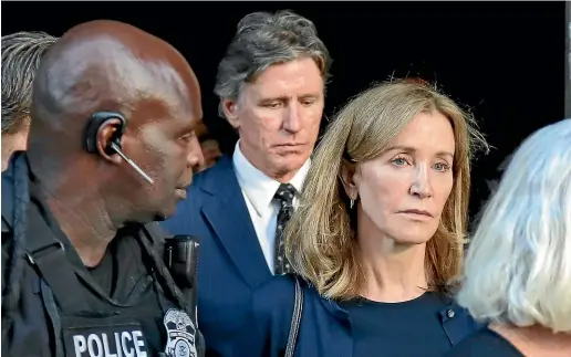  ?? AP ?? Actress Felicity Huffman leaves federal court accompanie­d by her brother, Moore Huffman Jr, centre, after her sentencing in a nationwide college admissions bribery scandal.