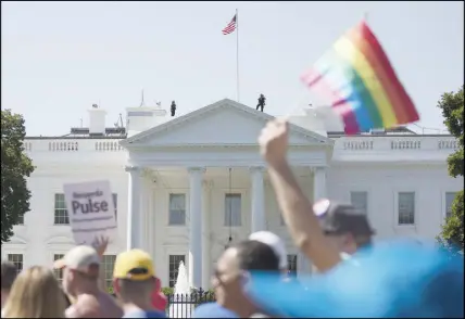  ?? AP PHOTO ?? Equality March for Unity and Pride participan­ts march past the White House in Washington. Most LGBT-rights activists never believed Donald Trump’s campaign promises to be their friend. With his move to ban transgende­r people from