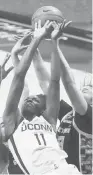  ?? DAVID BUTLER II/AP ?? UConn forward Mir McLean battles for a rebound against Georgetown on Saturday in Storrs. Despite Paige Bueckers and Anna Makurat out of the lineup, UConn rolled to a 72-41 victory.