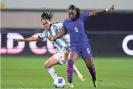  ?? RYAN SUN/AP ?? United States forward Jaedyn Shaw, front, and Argentina defender Eliana Stábile vie for the ball Friday in Carson, Calif.