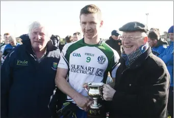  ??  ?? AGB captain Stephen Hurley receives the League cup from Fr Liam Dunne.