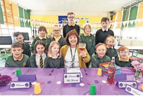  ?? ?? Raising a toast Mrs Kennedy enjoys a soft drink with some of her pupils