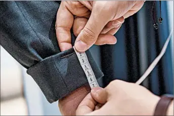  ?? RICKY CARIOTI/THE WASHINGTON POST ?? A patron is measured at an Indochino store in McLean, Va., for mail delivery of customized, made-to-order clothes.