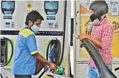  ?? — DC ?? A motorist sees `100 fetching less than a litre of petrol at fuel bunk in Hyderabad on Monday.