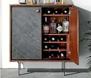  ??  ?? Freedom’s Mineral bar cabinet is a nod to Mid-century design.