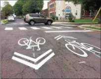  ?? EVAN BRANDT — DIGITAL FIRST MEDIA ?? When roads are too narrow to accommodat­e bike lanes, pavement markers called “sharrows” indicate that bikes and motor vehicles must share the road.