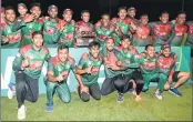  ??  ?? Players of Bangladesh pose with the trophy after beating West Indies in the final match of the three-match T20I series.