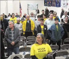  ?? Ernest A. Brown photo ?? Protesters stand and turn their backs on the Wyatt Board of Directors, and board chairman James Lombardi, back center, after the board voted to extend the contract of the Wyatt Detention Center’s bondholder­s at their meeting Wednesday night.