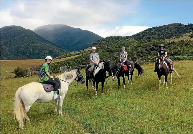  ??  ?? Fiona, far right, with the intrepid Woollin family on their first horse trek.