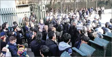  ?? STRINGER/AFP ?? Iranian students scuffle with police at the University of Tehran during a demonstrat­ion driven by anger over economic problems, in the capital Tehran on Saturday.